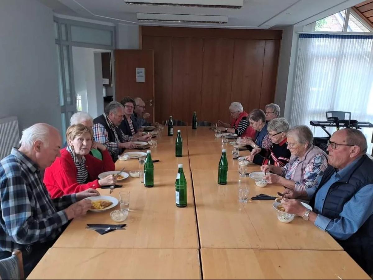 Menschen sitzen zusammen und essen